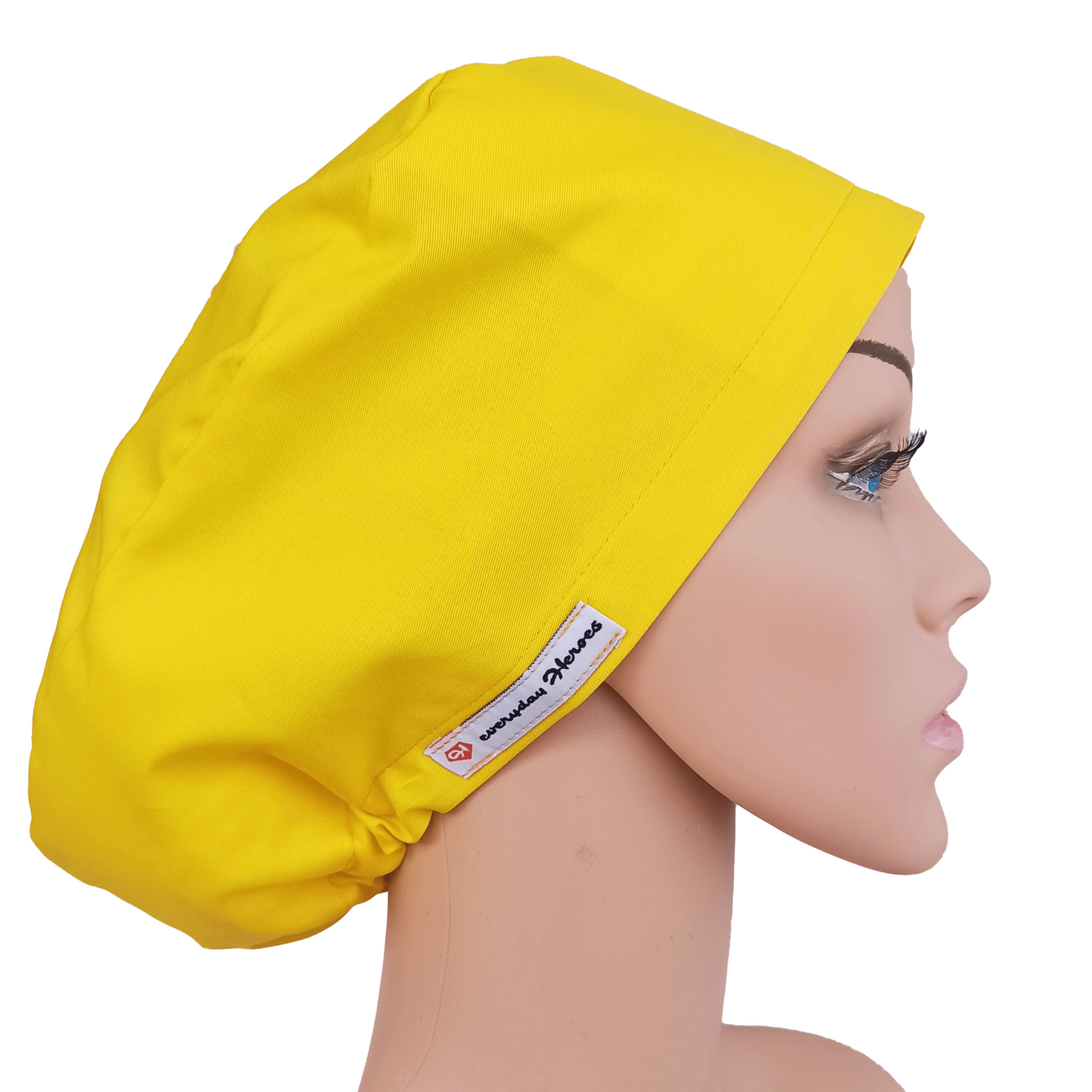 Smiling woman wearing a yellow euro-style scrub cap. Lightweight, breathable, and ideal for nurses, surgeons, and medical professionals. Perfect surgical hat for women who want comfort and cheerful style in the operating room.