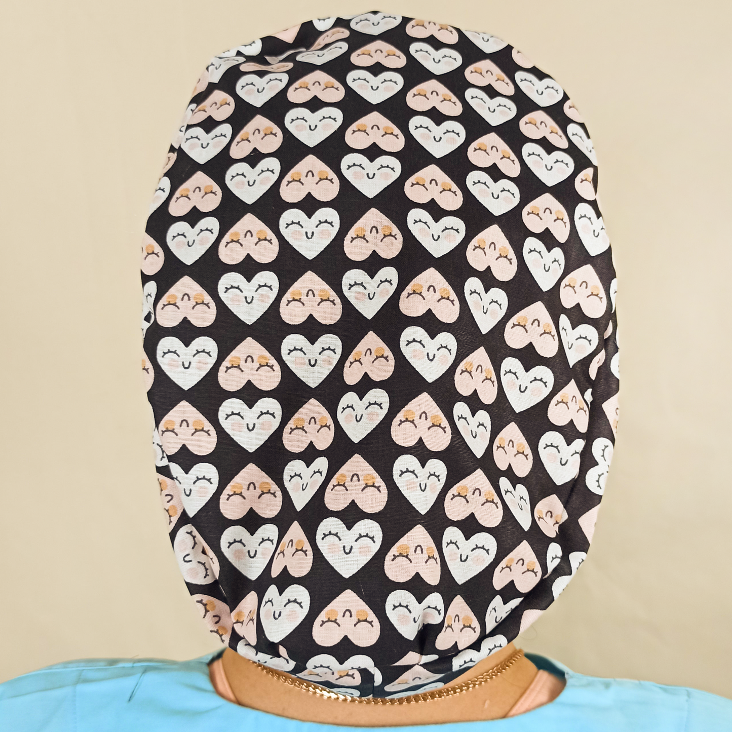 Floral custom satin lined scub cap for women pink ribbon for your ponytail at back, a nurse wearing and smilling this floral scrub cap