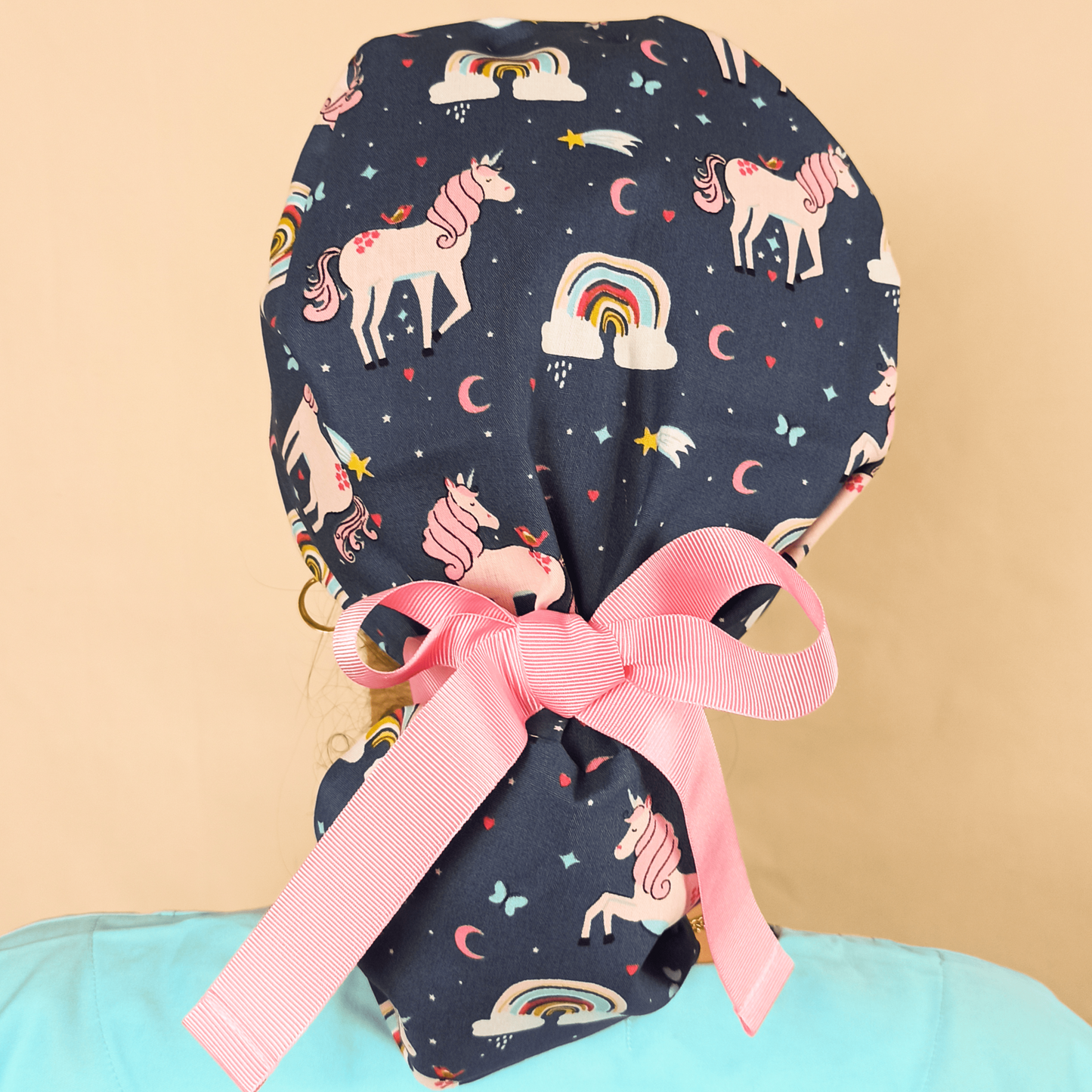 ponytail scrub cap with unicorns theme and rainbows on it , blue pink ribbons and satin lined inside or your name with embroidery customization service from our shop