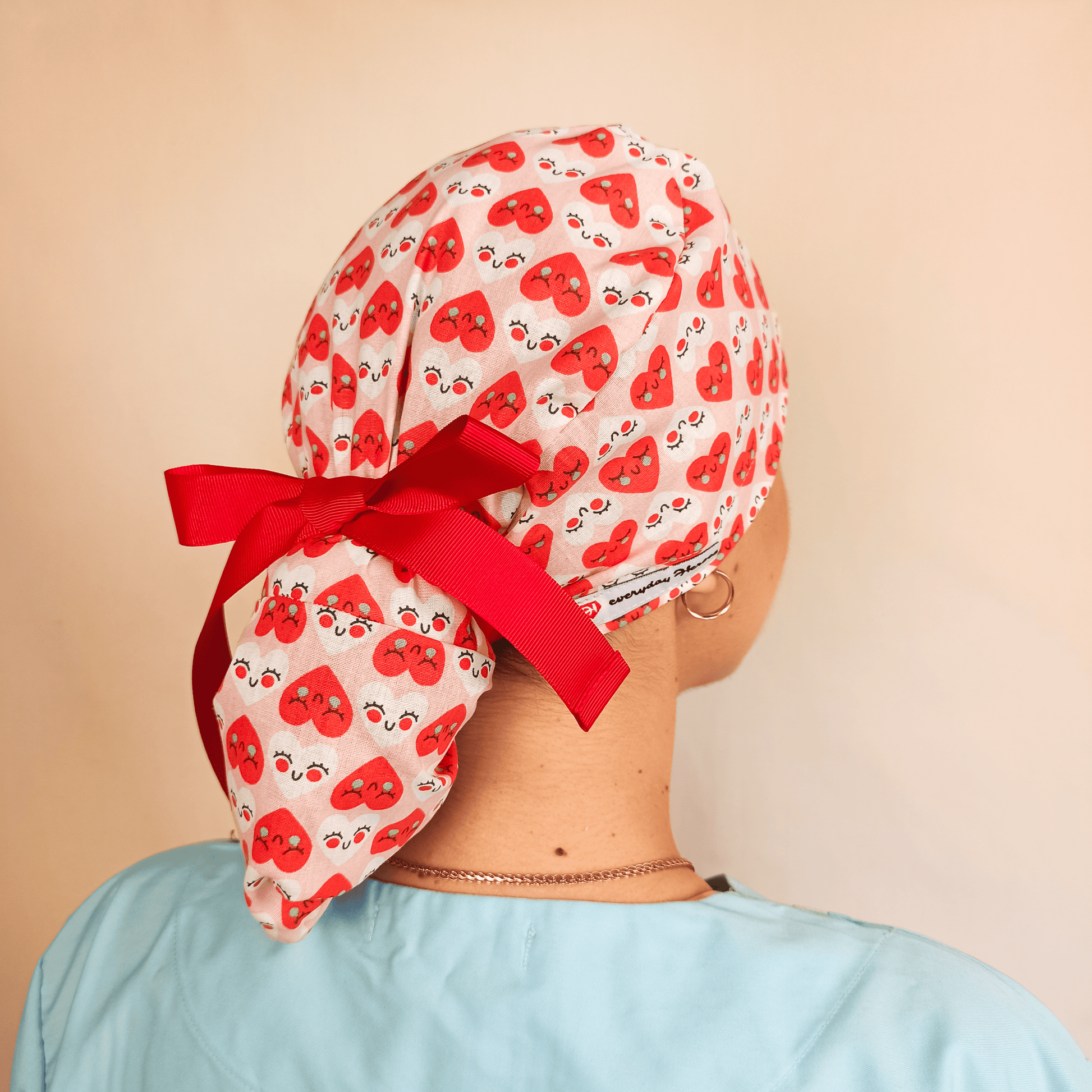 scrub caps, heart scrub cap, cute scrub caps, nurse scrub caps, medical caps for women, everyday beauty scrub cap, fun surgical caps, Valentine scrub cap, stylish scrub hats, medical fashion, printed scrub caps, scrub cap with ribbon, love print scrub cap, healthcare accessories, red and pink scrub caps, unique scrub caps for nurses