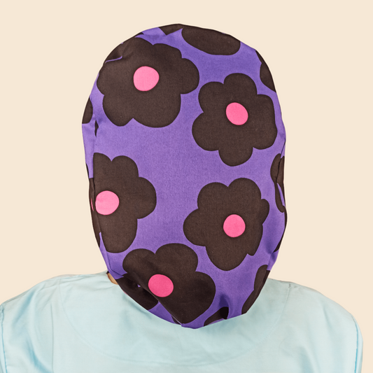 purple scrub cap with black and pink daisies