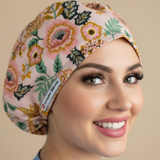 Consistent model in profile looking upward wearing blush pink botanical floral scrub cap