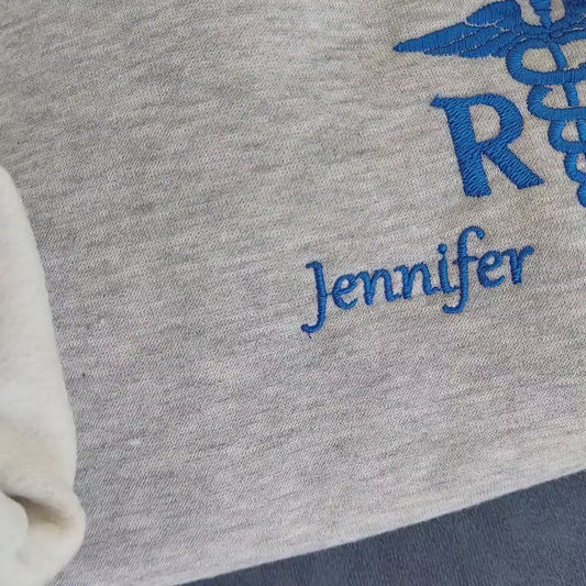 Sample shown with Royal Blue thread for name and caduceus & credentials on grey melange sweatshirt*