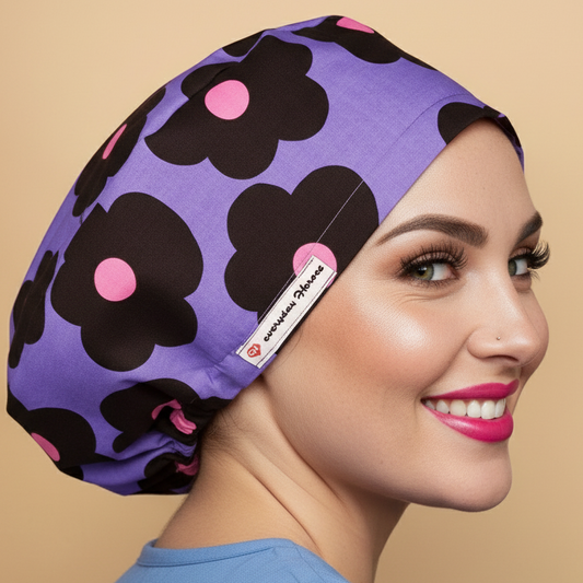 Cheerful daisies euro scrub caps women back side view with smiling healthcare professional - vibrant purple lavender bouffant featuring large black daisy flowers with pink centers - surgery scrub hats satin lined - surgeon gift idea anesthesia cap - surgical cap with name embroidery option - nurse gift - adjustable elastic fit - woman with hot pink lipstick green hazel eyes showing confident smile - Everyday Heroes brand label visible - professional medical headwear - retro mod floral patter