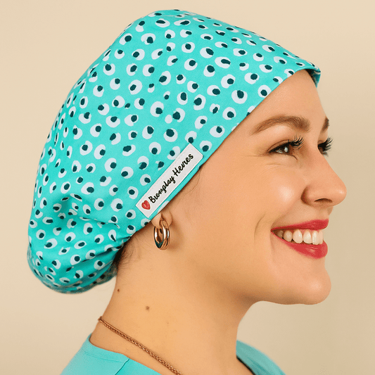 a woman wering a scrub hat that fits on her head , the cotton print i blue leopard . the style is euro scrub hat