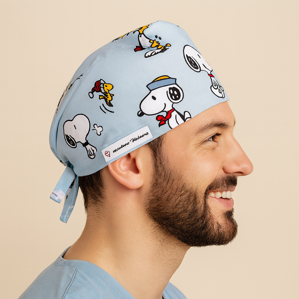 a men wearing a scrub cap for surgeons and he is smilling 