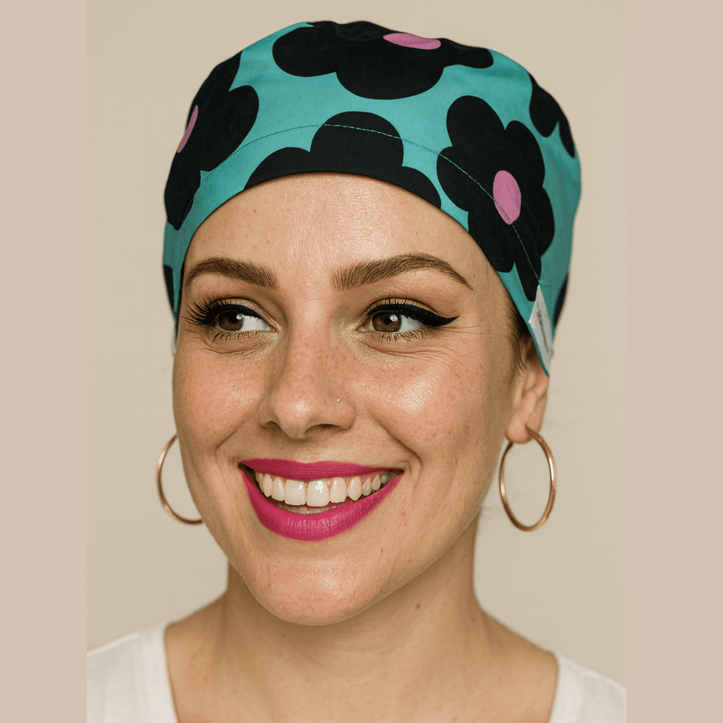 A woman with a bright smile and a colorful patterned headband is the focus of the image.