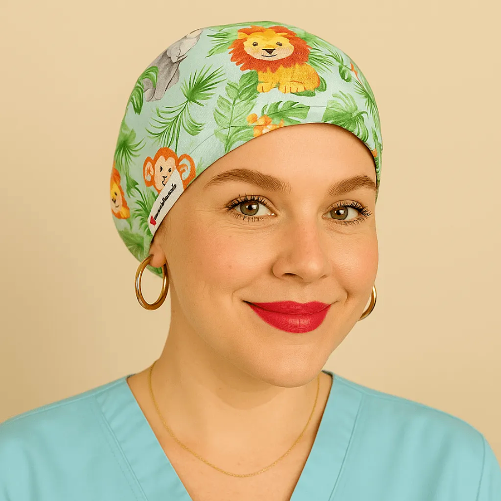 A woman wearing a green cap with a lion and monkey design, smiling at the camera.