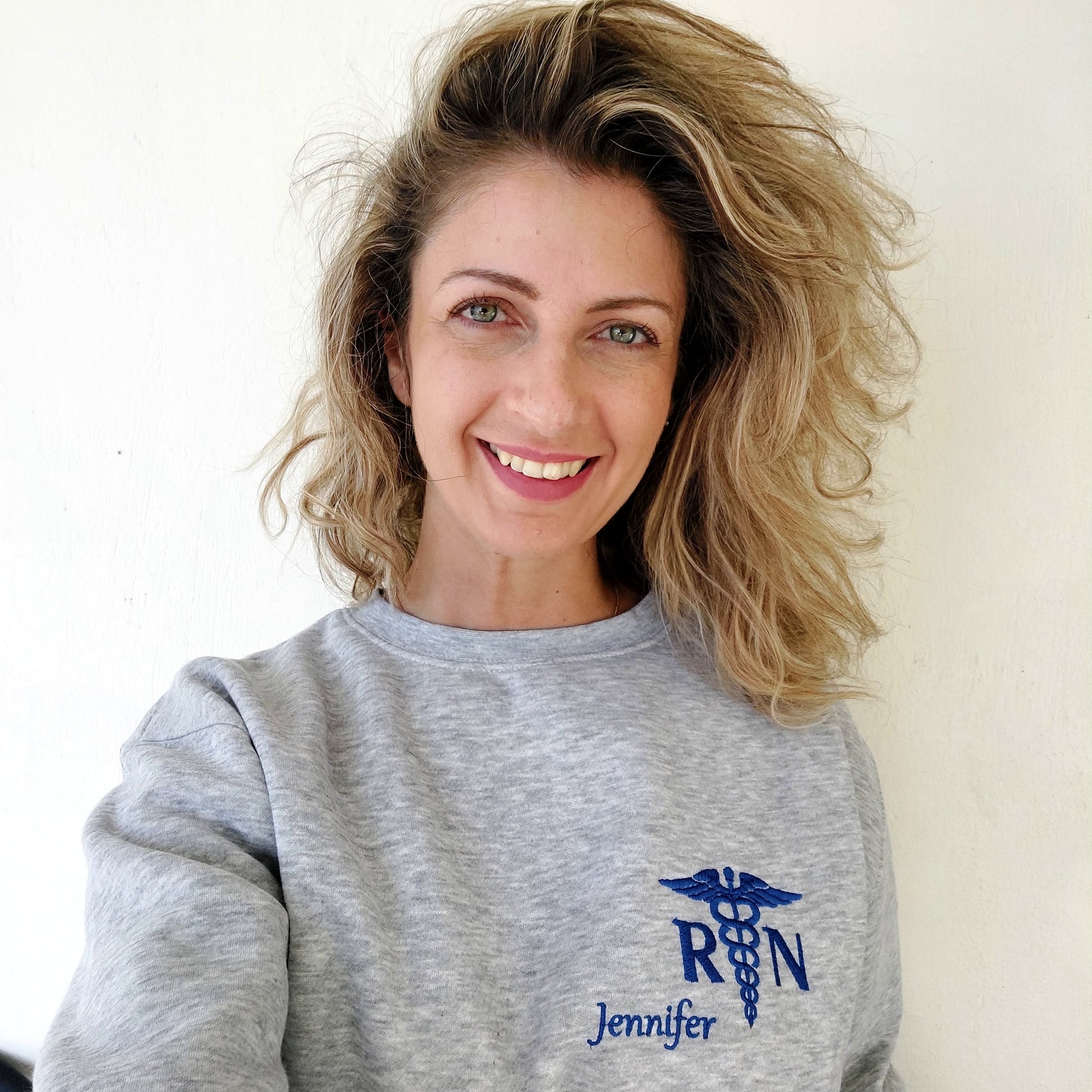 Awoman wearing and  shown with Royal Blue thread for name and caduceus & credentials on grey melange sweatshirt*