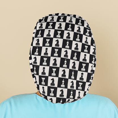 a person wearing a hat with a pattern of chess pieces on it.