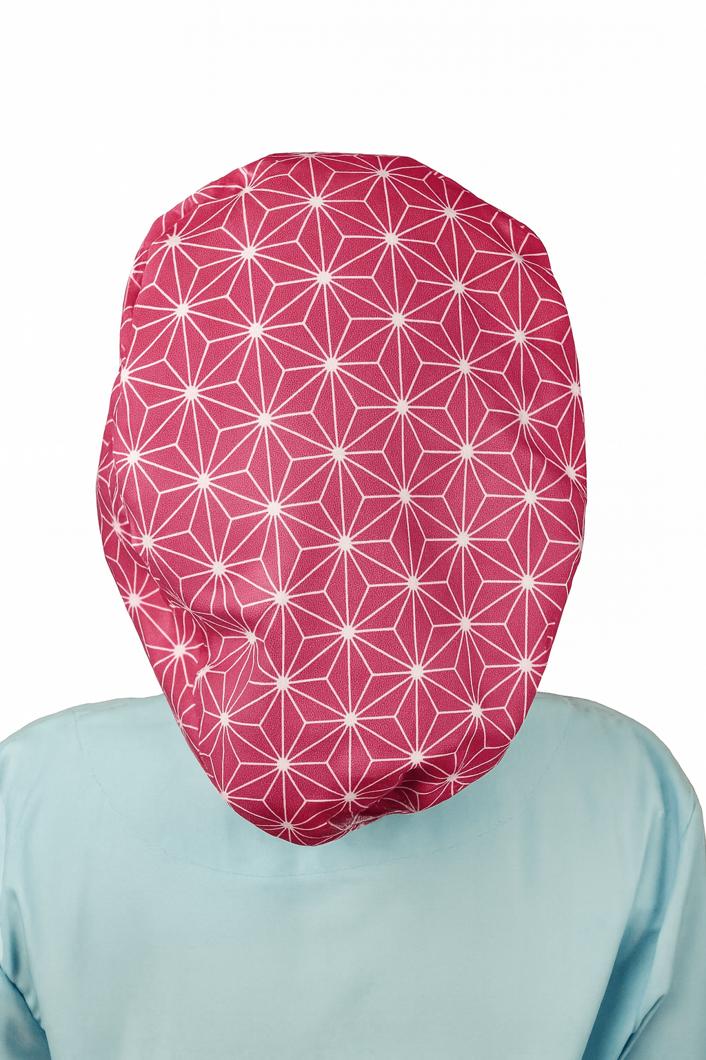 a woman wearing  apink scrub cap with abstract asanoha cotton print, the style is euro scrub hat its adjustable and she is smilling .