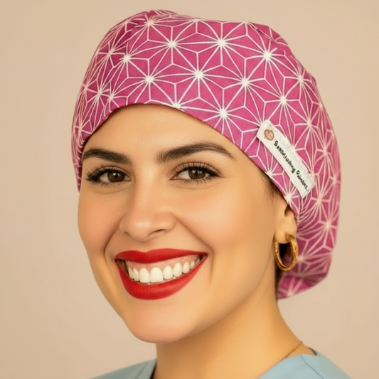 A woman wearing a pink patterned cap and a blue shirt is smiling at the camera.