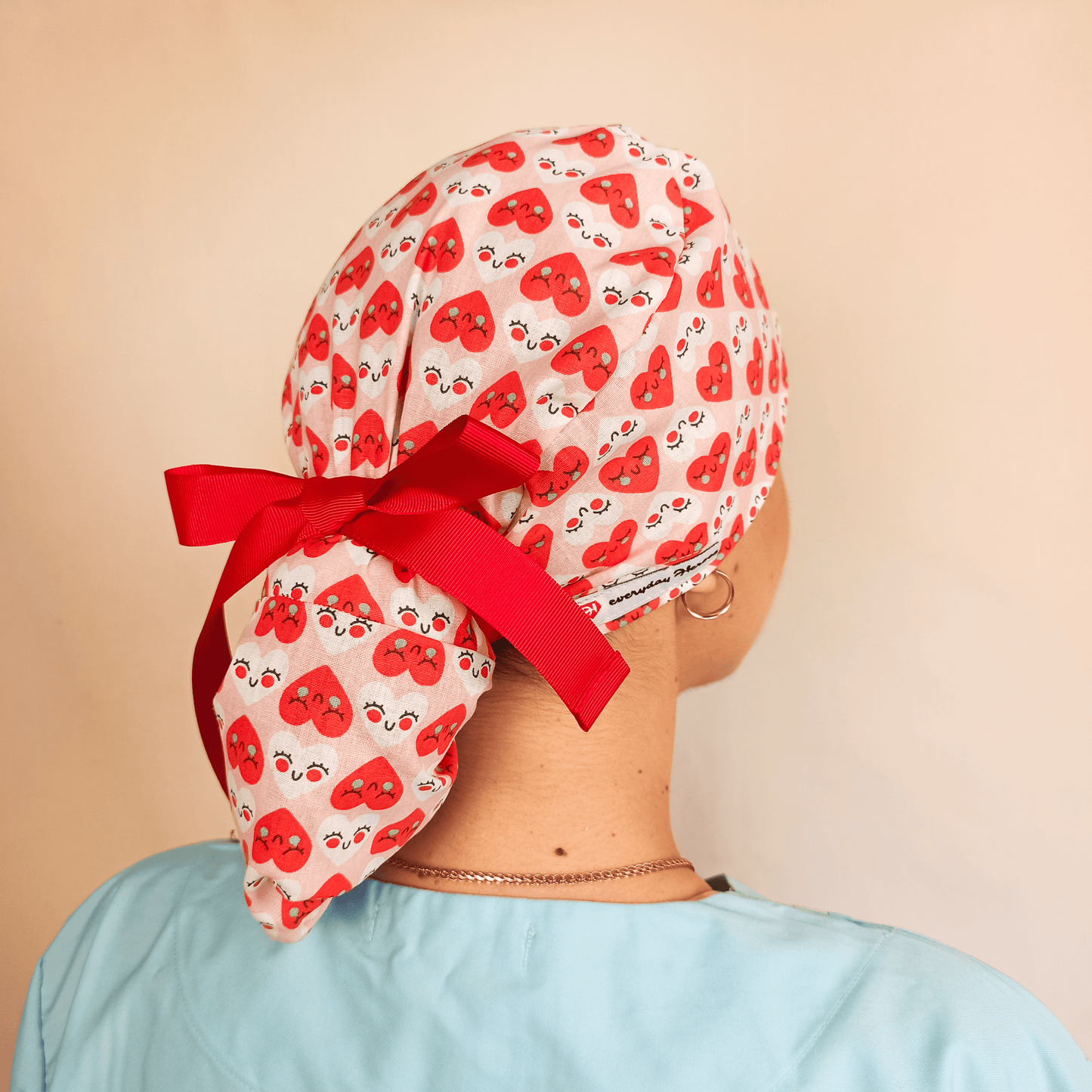scrub caps, heart scrub cap, cute scrub caps, nurse scrub caps, medical caps for women, everyday beauty scrub cap, fun surgical caps, Valentine scrub cap, stylish scrub hats, medical fashion, printed scrub caps, scrub cap with ribbon, love print scrub cap, healthcare accessories, red and pink scrub caps, unique scrub caps for nurses