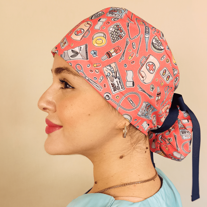 Pink ponytail scrub cap featuring a white embroidered heartbeat design. Comfortable and adjustable surgical hat ideal for nurses, doctors, and surgeons. A stylish and functional medical accessory perfect for long hospital or clinic hours.