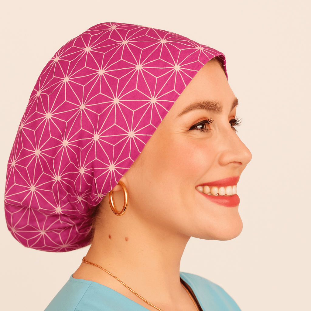 Smiling woman wearing a fuchsia Japanese Asanoha pattern euro scrub cap. Satin-lined and adjustable for comfort, this custom surgical hat is ideal for nurses, theatre staff, and medical professionals. Personalized with name embroidery for a unique touch.