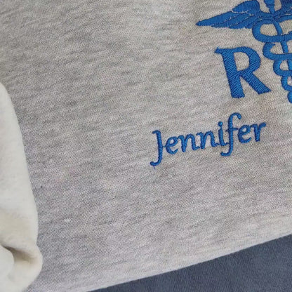Sample shown with Royal Blue thread for name and caduceus & credentials on grey melange sweatshirt*