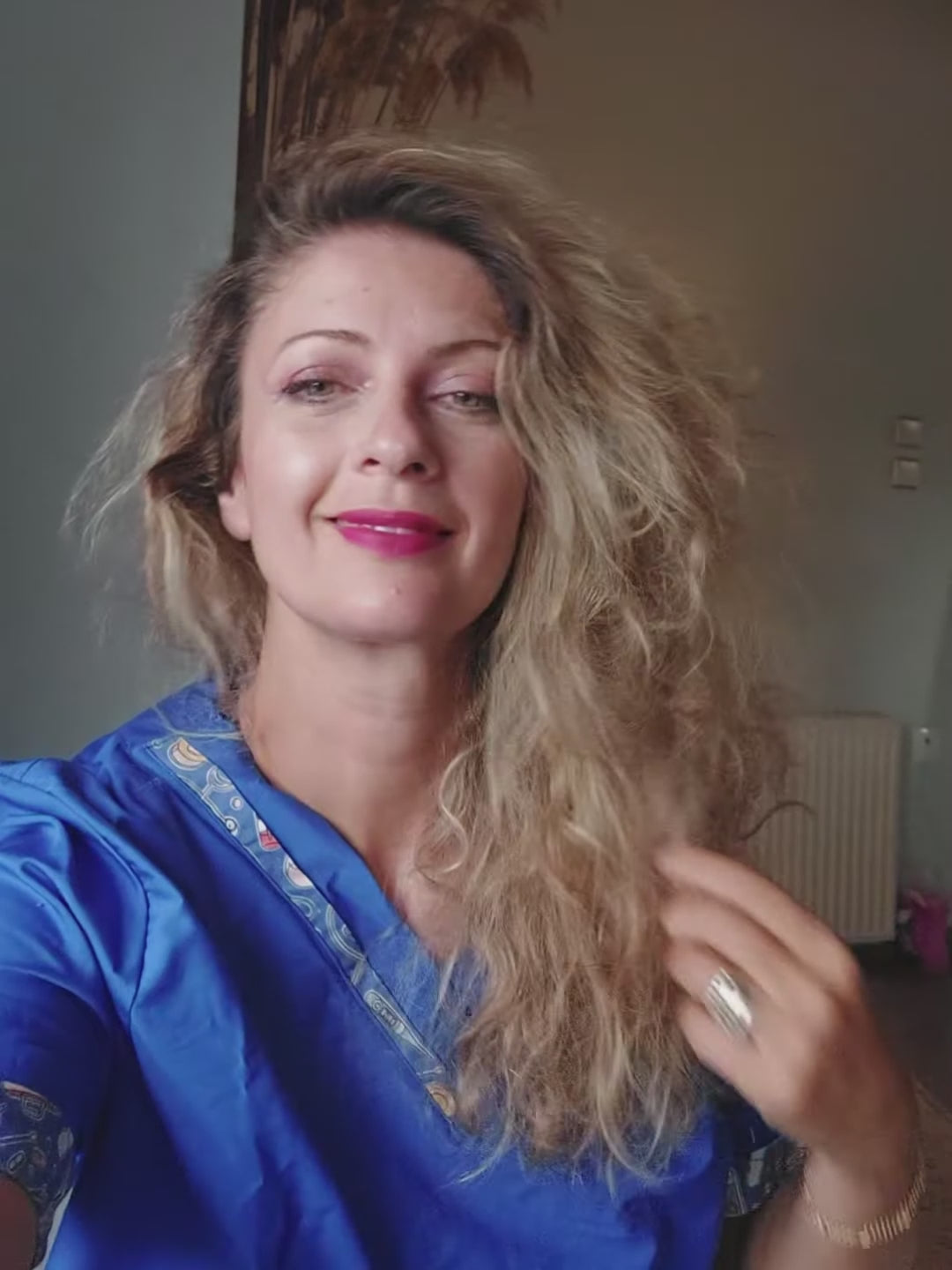 Load video: Video showing a young woman with long hair trying on several colorful scrub caps — featuring vibrant prints like hearts, leopard, and floral themes. Each cap is lined with smooth satin to protect the hair and includes a soft sweatband for comfort. The reel ends showing how the cap can be personalized with custom name embroidery, perfect for nurses and medical staff.