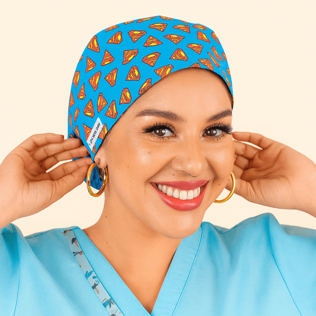Smiling woman wearing a bright blue euro scrub cap featuring a red and yellow superhero logo pattern. Fun cartoon movie theme surgical hat, ideal for nurses, surgeons, and medical staff who love superhero style. Lightweight and comfortable for daily hospital wear.