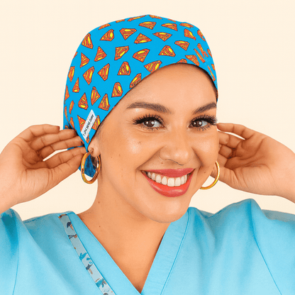 Smiling woman wearing a bright blue euro scrub cap featuring a red and yellow superhero logo pattern. Fun cartoon movie theme surgical hat, ideal for nurses, surgeons, and medical staff who love superhero style. Lightweight and comfortable for daily hospital wear.