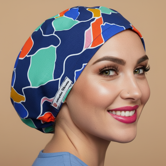 Scrub caps women front view playful wink - blue waves abstract bouffant with vibrant navy royal blue turquoise orange pink yellow shapes - satin lined scrub cap nurse gift - OR surgery euro scrub hats for dental surgical cap medical assistant - custom name embroidery option - adjustable elastic fit - woman with hot pink lipstick green hazel eye winking playfully - Everyday Heroes brand label visible - professional medical headwear - modern abstract wave pattern - gift for nurses doctors 