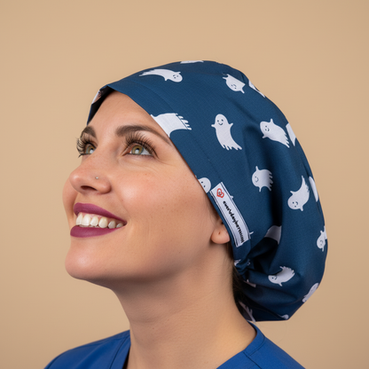 Woman in profile looking up with heartfelt smile wearing navy ghost scrub cap
